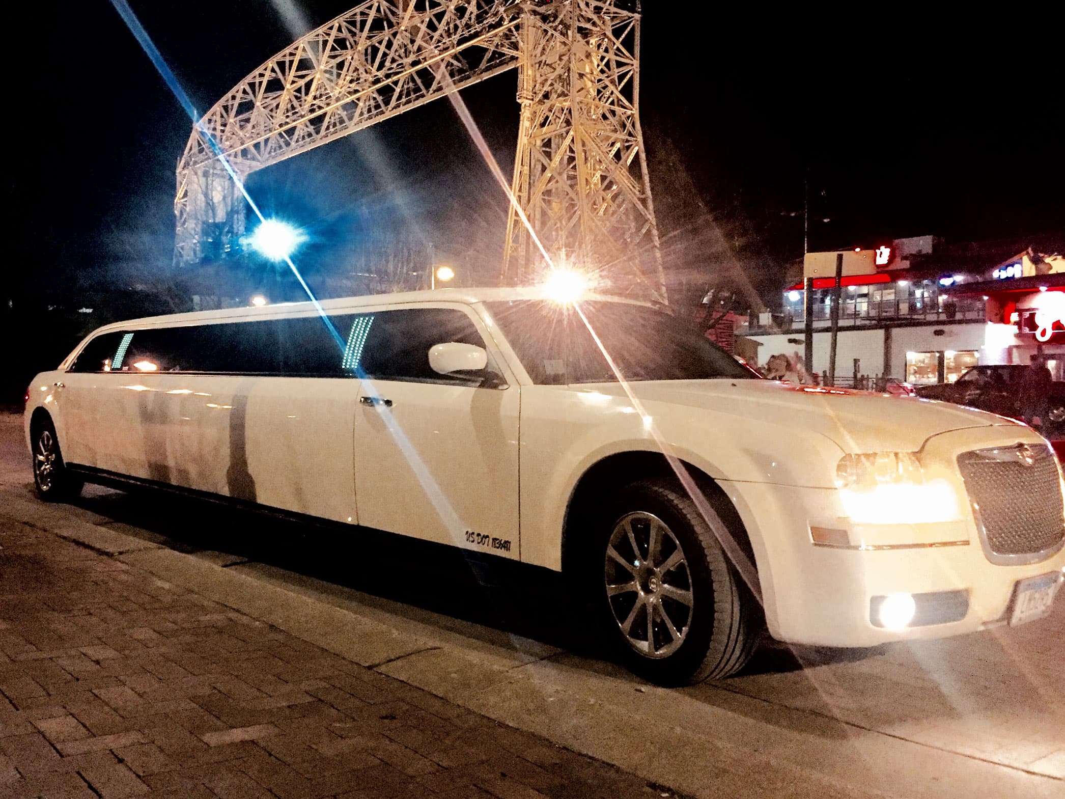 white Chrysler 300 Stretch limousine at night
